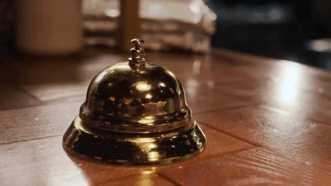 Brass service bell on a hotel front desk